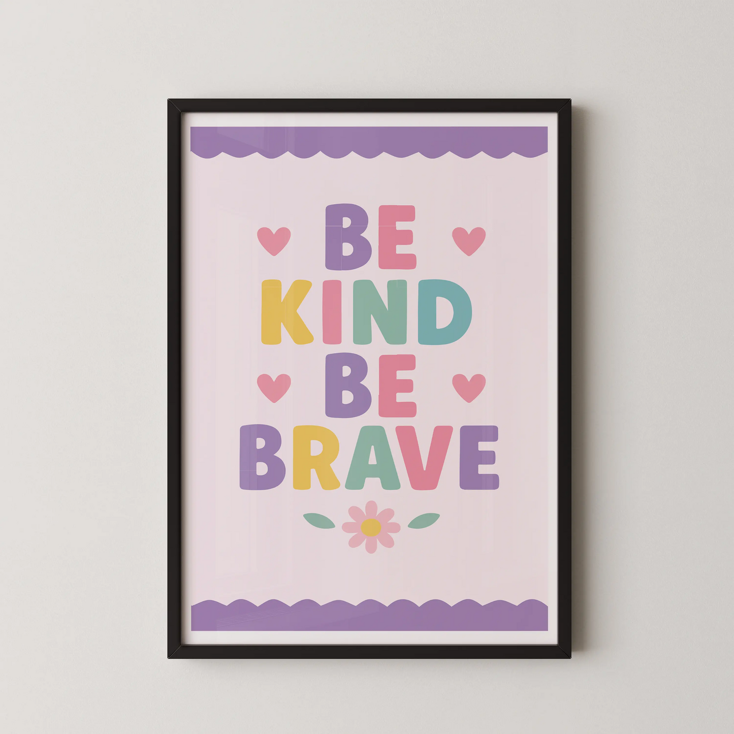A modern typographic poster with the words "BE KIND BE BRAVE" in pastel rounded letters, adorned with pink hearts and a daisy.