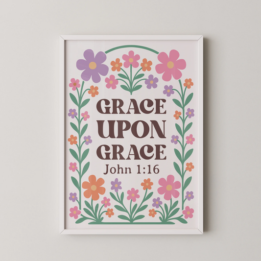 A modern floral quote wall art featuring the words "Grace Upon Grace" surrounded by whimsical flowers in lavender, pink, mint green, and orange.