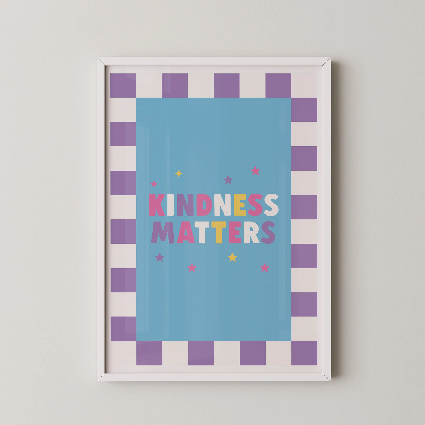 A Pop Art style poster with the bold multicolored typographic phrase KINDNESS MATTERS on a sky-blue panel, framed by a lavender checkerboard border.