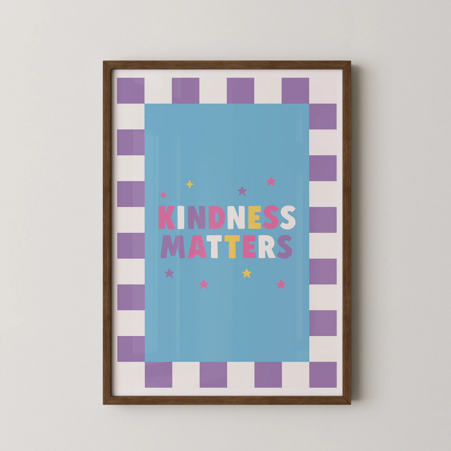 A Pop Art style poster with the bold multicolored typographic phrase KINDNESS MATTERS on a sky-blue panel, framed by a lavender checkerboard border.